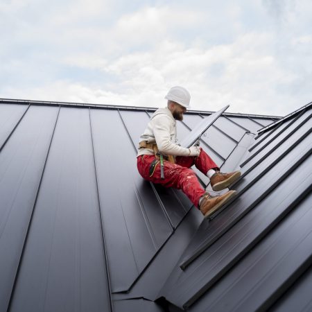 full-shot-man-with-helmet-sitting-roof-scaled.jpg
