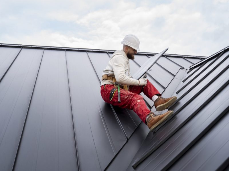 full-shot-man-with-helmet-sitting-roof-scaled.jpg