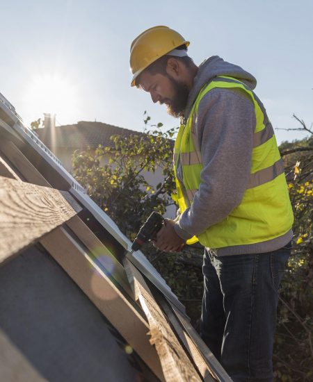 man-working-roof-with-drill-1-scaled.jpg