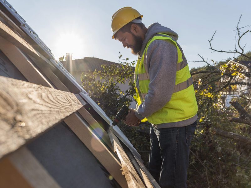 man-working-roof-with-drill-1-scaled.jpg